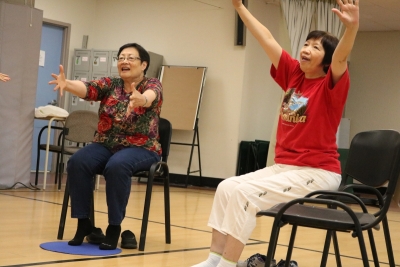 Attendees stretch out their arms with joy