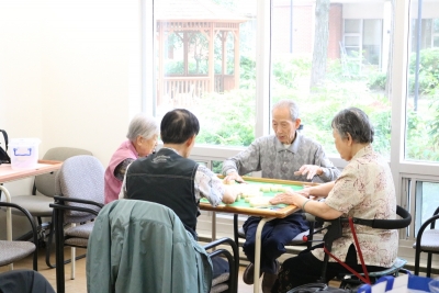 SPLC clients sit in on a sunny day and play Machet