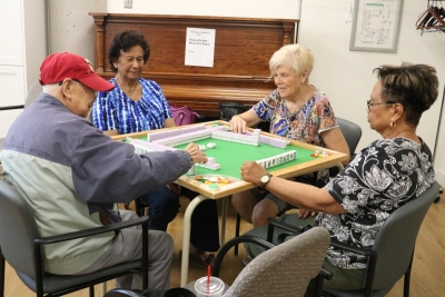 SPLC clients, Isha, Barb, and Yvone play Machet with Jackie