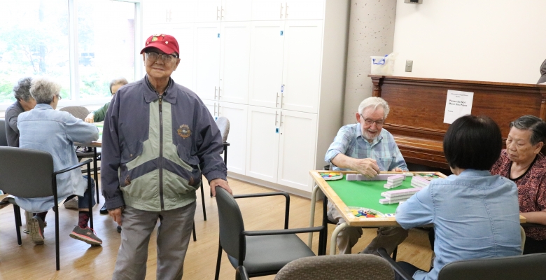 SPLC volunteer Jackie Mac watches as his students play Machet
